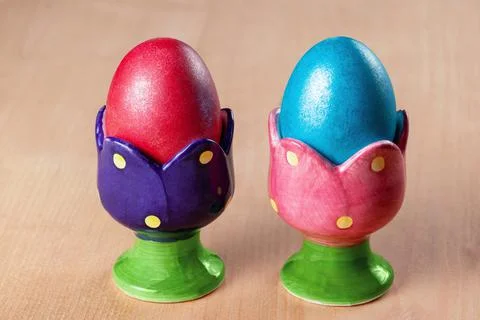 Colored easter eggs in egg cups Stock Photos