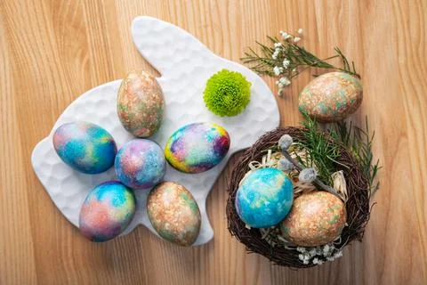 Colored easter eggs in forest nest and willow Stock Photos