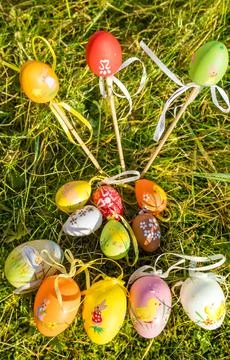 Colored easter eggs in the fresh, green spring landscape. Stock Photos