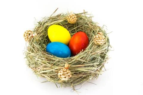 Colored easter eggs in grass nest with bumps Stock Photos