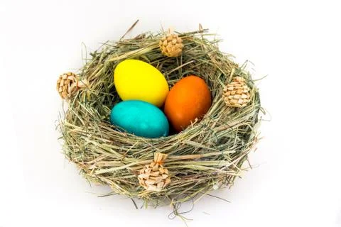 Colored easter eggs in grass nest with bumps Stock Photos