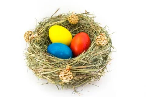 Colored easter eggs in grass nest with bumps Stock Photos