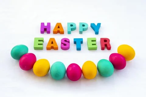 Colored Easter eggs. Happy Easter inscription on the table Stock Photos