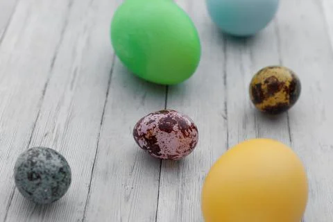 Colored Easter eggs on a light wooden background. Easter holiday with colored Stock Photos