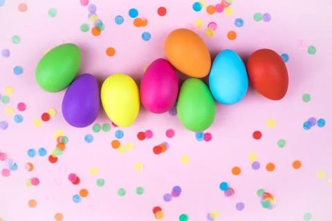 Colored Easter eggs on pink background. Flatlay. Stock Photos
