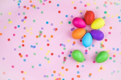 Colored Easter eggs on pink background. Flatlay. Stock Photos