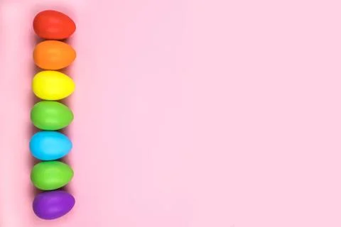 Colored Easter eggs on pink background. Flatlay. Stock Photos