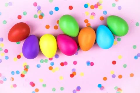 Colored Easter eggs on pink background. Flatlay. Stock Photos