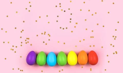 Colored Easter eggs on pink background. Flatlay. Stock Photos