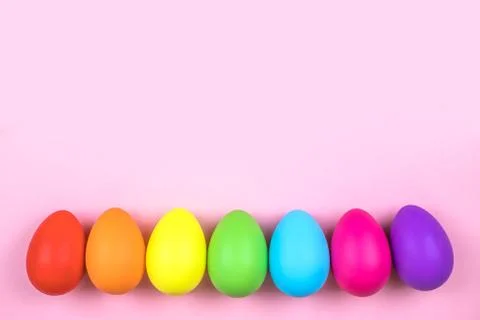 Colored Easter eggs on pink background. Flatlay. Stock Photos