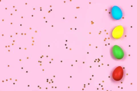 Colored Easter eggs on pink background. Flatlay. Stock Photos