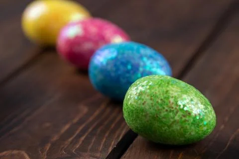 Colored easter eggs placed in line. holiday concept with copy space, side vie Stock Photos
