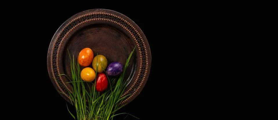 Colored easter Eggs in a plate with black background and copy space. With gra Foto stock