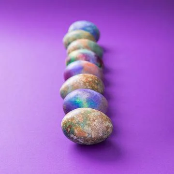 Colored easter eggs on a violet trend Stock Photos