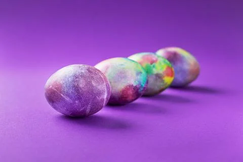 Colored easter eggs on a violet trend Stock Photos
