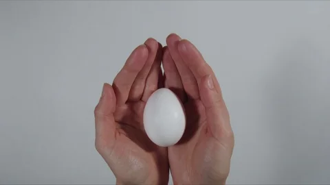 Colored Easter eggs in woman hands stop motion Stock Footage 104862062