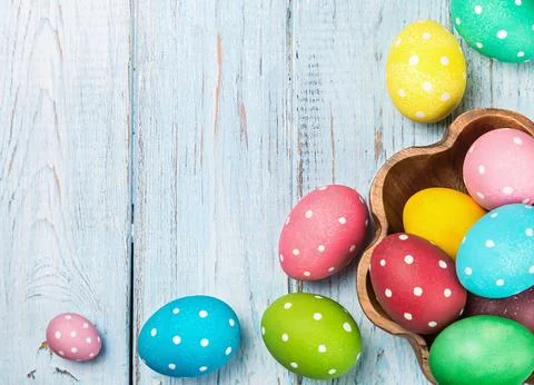 Colored Easter eggs on wooden background Stock Photos