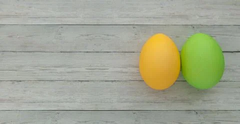 Colored Easter eggs yellow and green on a light wooden background 写真素材