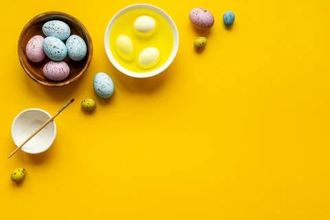 Colored Easter eggs with yellow dye. Top view Stock Photos