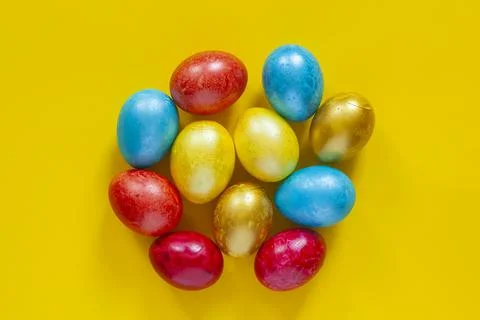 Colored Easter eggs on yellow Stock Photos