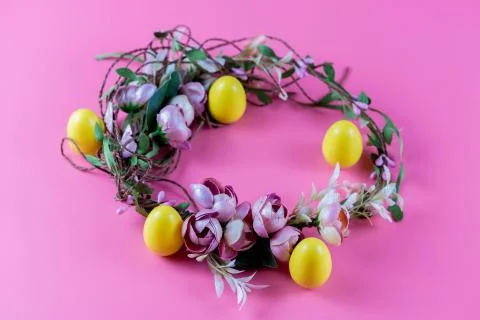 Colored Easter wreath and plastic eggs on a pink background Stock-Fotos