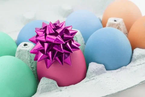 Colored egg with bow Stock Photos