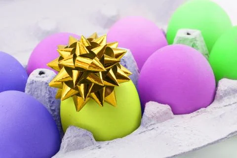 Colored egg with bow Stock Photos
