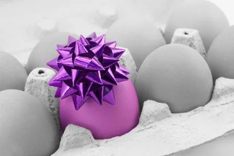Colored egg with bow Stock Photos