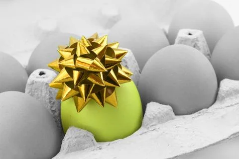 Colored egg with bow Stock Photos