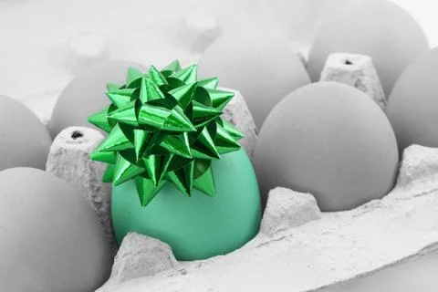 Colored egg with bow Stock Photos