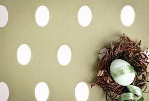 Colored egg in a small nest Stock Photos