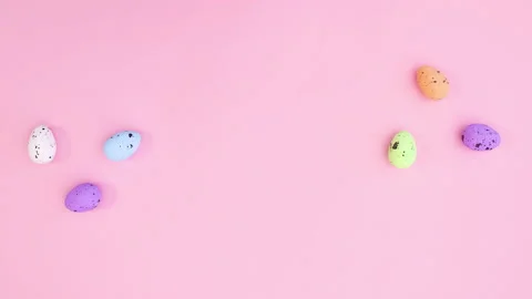 Colored eggs appear on left and right side of pink theme. Stop motion Видео 148184115