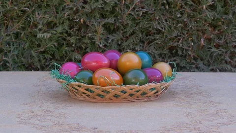 Colored eggs in basket outdoors Stock Footage 83548568