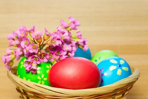Colored  eggs in basket Stock Photos