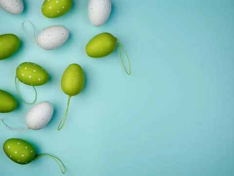 Colored eggs on blue background. Overhead view with copy space. Stock Photos