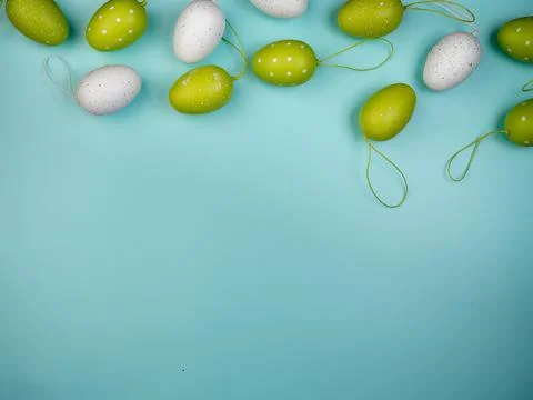Colored eggs on blue background. Overhead view with copy space. Stock Photos