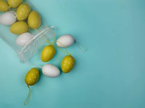 Colored eggs on blue background. Overhead view with copy space. Stock Photos