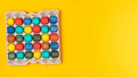 Colored eggs in a cardboard box disappear and appear Stock Footage 127103560