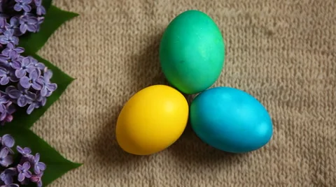 Colored eggs different colors with beautiful flowers, old style background 스톡 동영상 62834719
