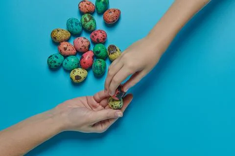 Colored eggs for easter and two hands Stock Photos