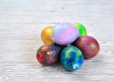Colored eggs on a gray background lie in the shape of a pyramid Stock Photos