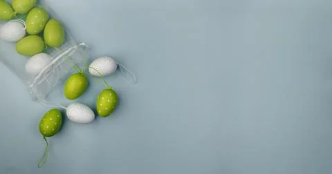 Colored eggs on grey background. Overhead view with copy space. Foto stock