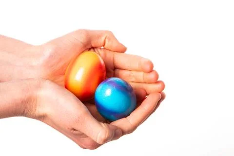 Colored eggs with hands tapping and crushing eggs Stock Photos