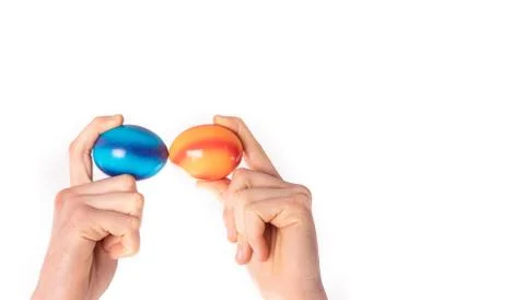 Colored eggs with hands tapping and crushing eggs Stock Photos