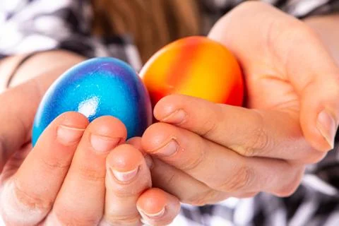 Colored eggs with hands tapping and crushing eggs Stock Photos