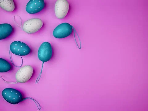 Colored eggs on pink background. Overhead view with copy space. Stock Photos