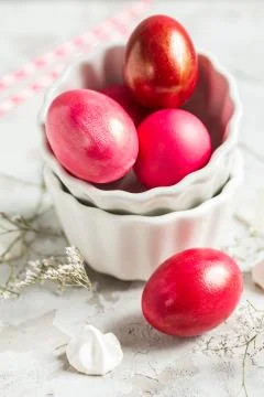.Colored eggs in a white bowl on the Easter holiday Stock Photos