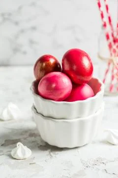 .Colored eggs in a white bowl on the Easter holiday Stock Photos