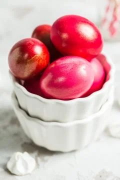 .Colored eggs in a white bowl on the Easter holiday Stock Photos