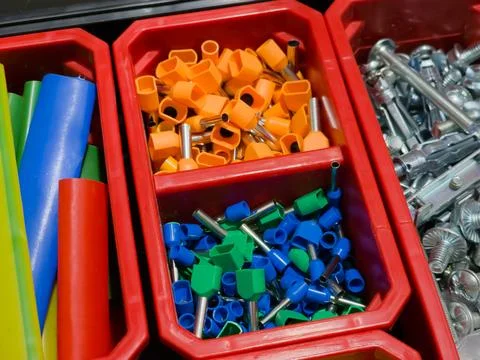 Colored electrical wire connectors in a plastic box 스톡 사진